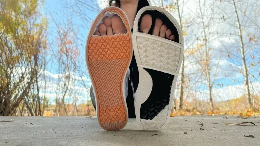 Two shoe soles cut open at the toes, showing the room available for the feet